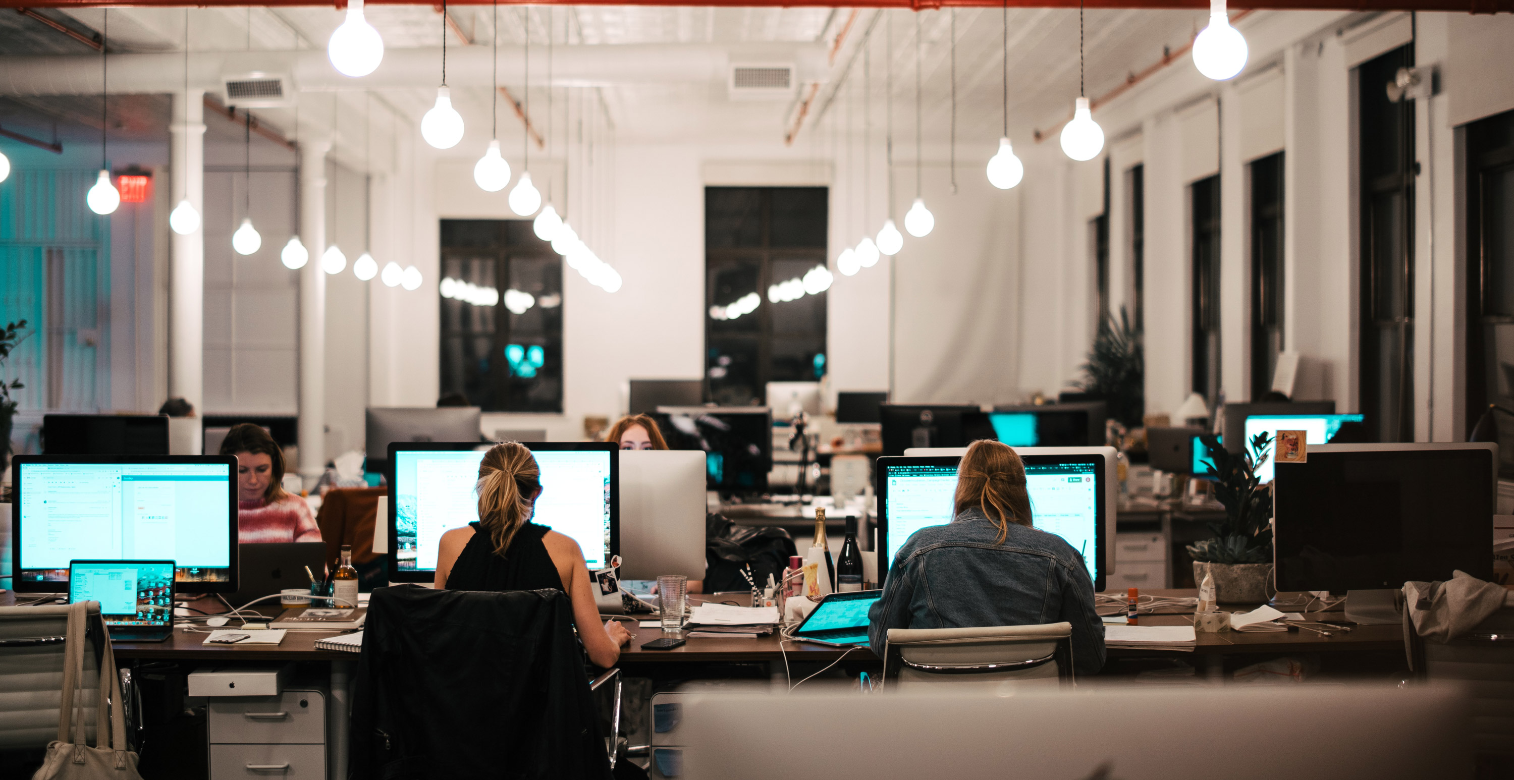 An office setting showing people at their desks. 